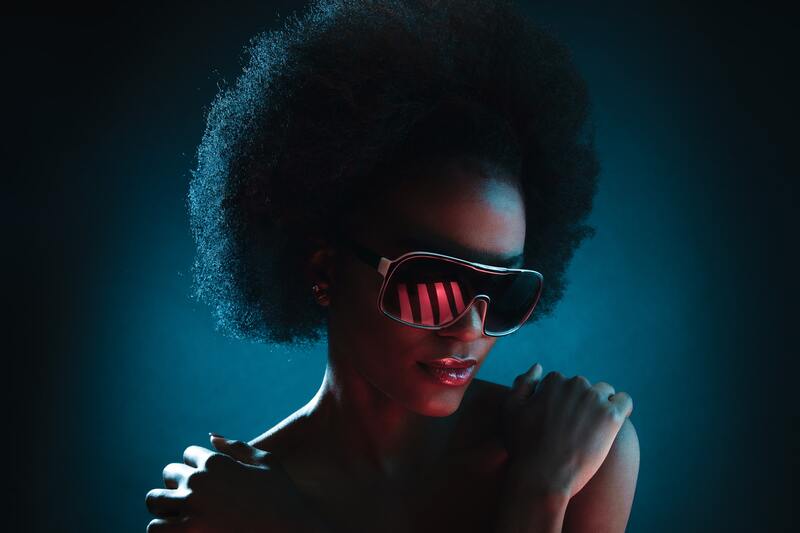 Black woman with Afro and dark sunglasses