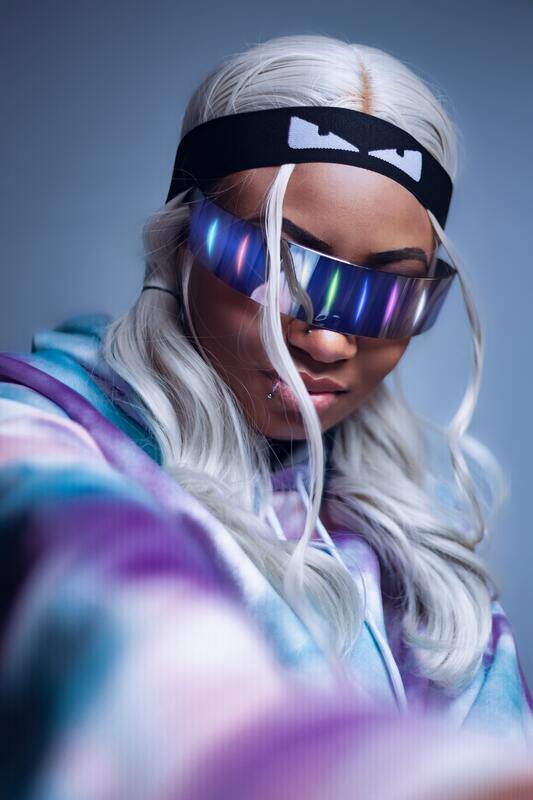 Black woman with long white hair and sunglasses