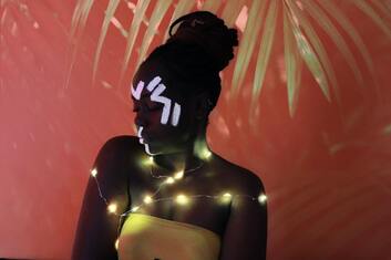 Black Woman with yellow light wires and white face paint