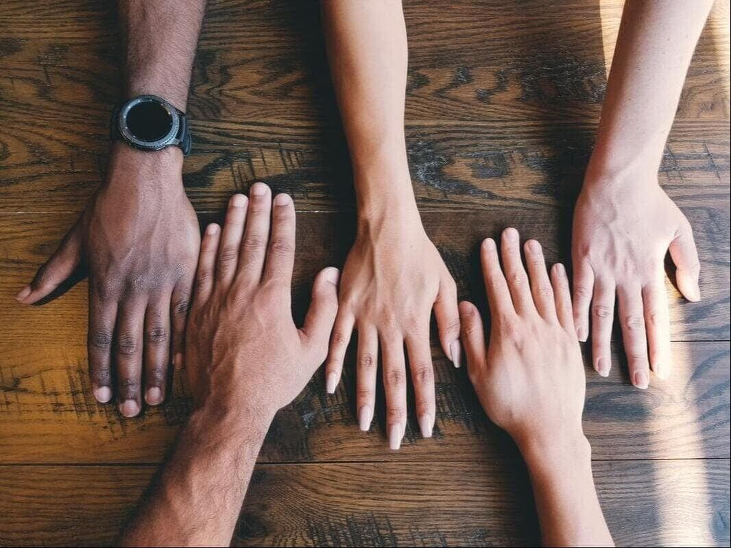 five hands each a different brown or beige