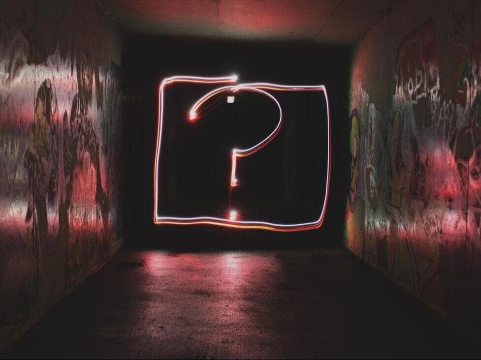 question mark at the end of graffiti hallway