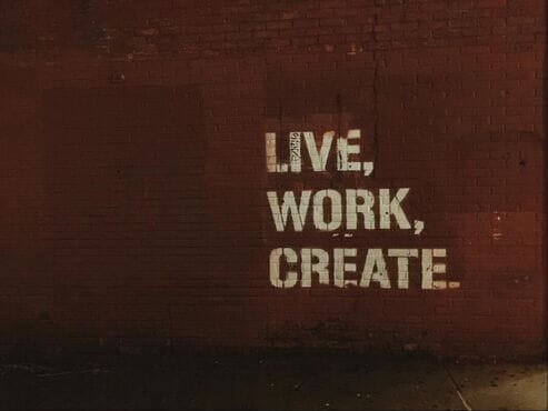 red brick wall with bold white print words